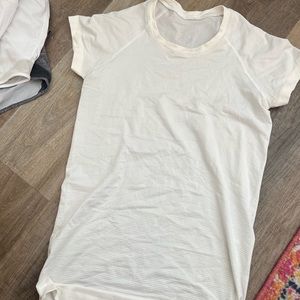 White lulu lemon athletic shirt. Size 6. Only worn 4 times. Excellent condition